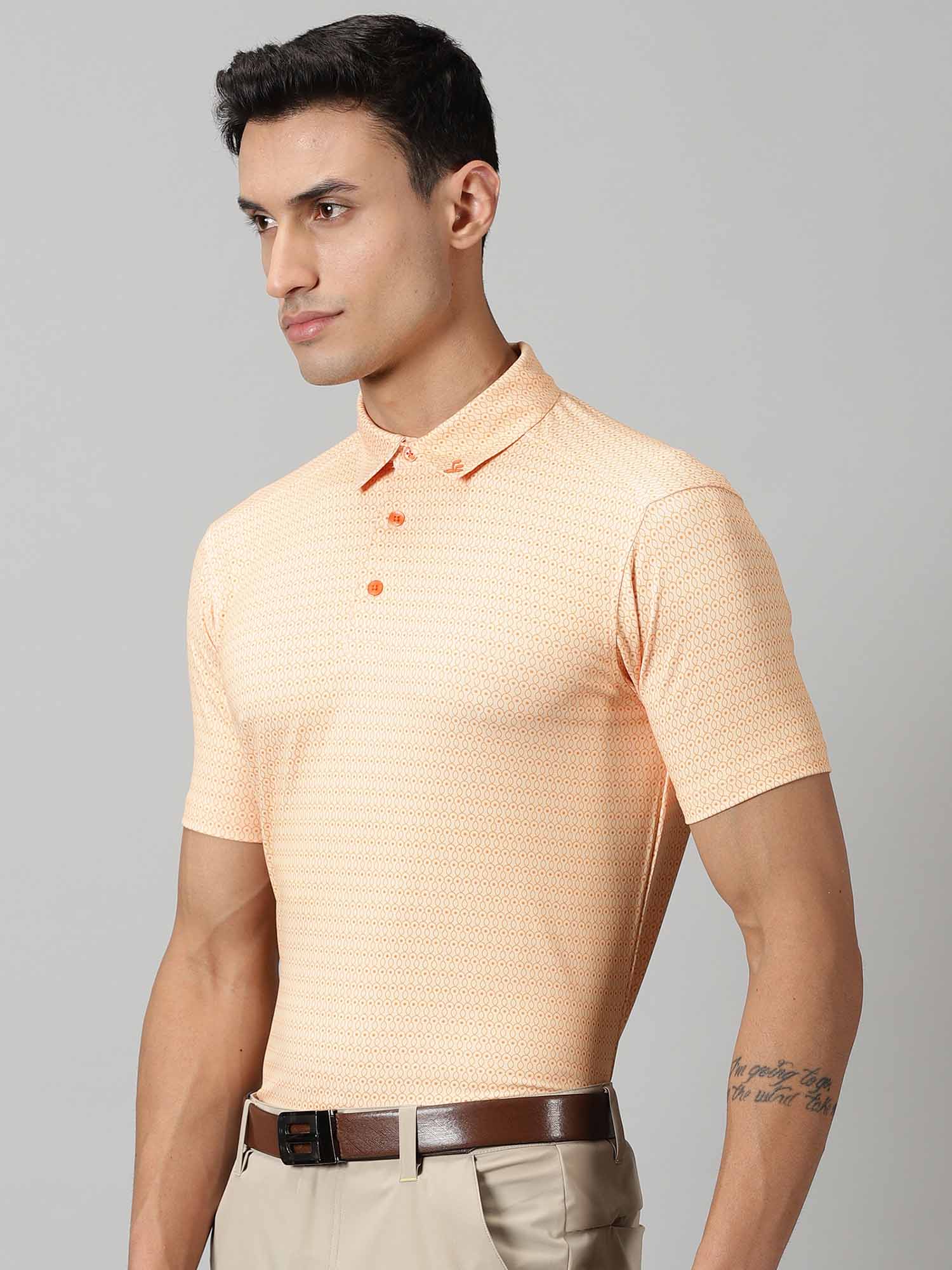 Image of All-over printed short sleeved polo sports geometric patterns in sorbet and exotic orange complete with a handmade collar. The silicon detailing adorns the front and back.  From Firstcut.co