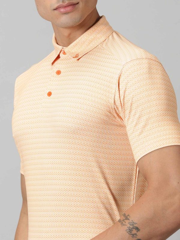 Image of All-over printed short sleeved polo sports geometric patterns in sorbet and exotic orange complete with a handmade collar. The silicon detailing adorns the front and back. From Firstcut.co